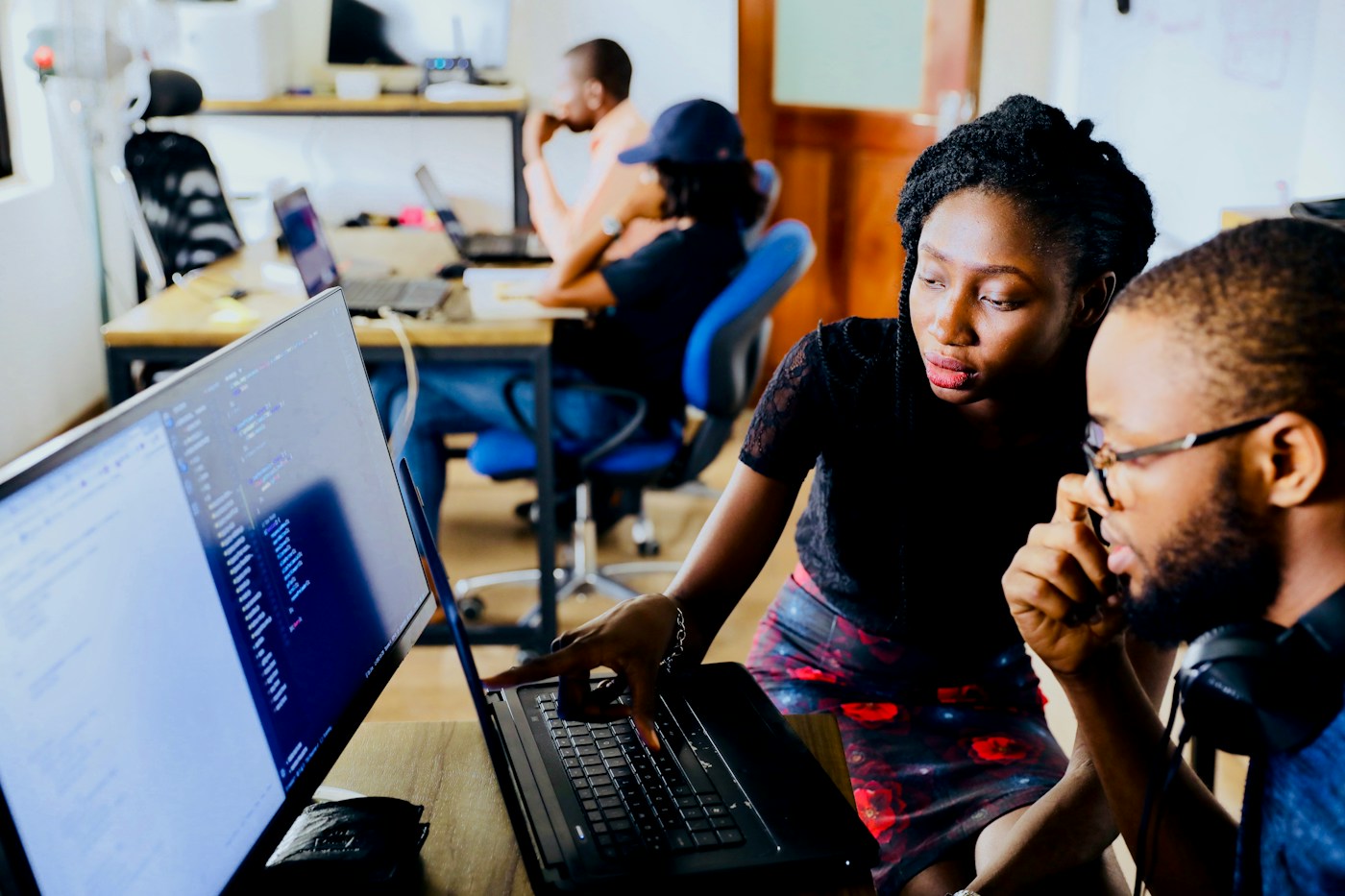 Technology professionals discussing a product in a modern workspace